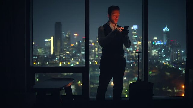 A Young Professional in a Chic Hotel Room is Communicating Late at Night, Embracing the Atmosphere
