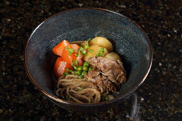 NikuJaga, a classic Japanese dish made with thinly sliced ​​beef, potatoes, carrots, onions, Ito Konnyaku or shirataki noodles, snow peas, soy sauce, sugar, sake, kombu dashi broth, dashi, and vegetab