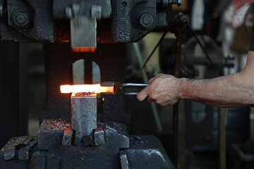 trabajador de hierro forjador con las tenazas forjando hierro caliente con las manos en el martillo neumático  país vasco legazpi 4M0A6482-as25