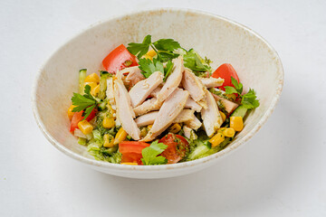 Crisp greens with juicy tomatoes, grilled chicken strips, and sweet corn create a refreshing meal