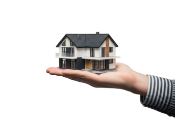 Hand holding a small model of a modern twostory house with dark roof isolated on transparent background
