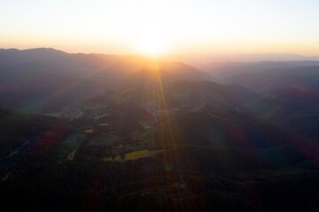 Evening sky in the mountains, on twilight. Background sunset / sunrise with clouds, light rays and other atmospheric effect. Beautiful sky. Wonderful mountains landscape.