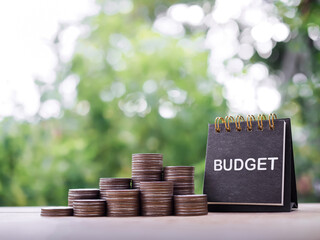 Desk calendar and stack of coins. The concept about budget planning and allocation