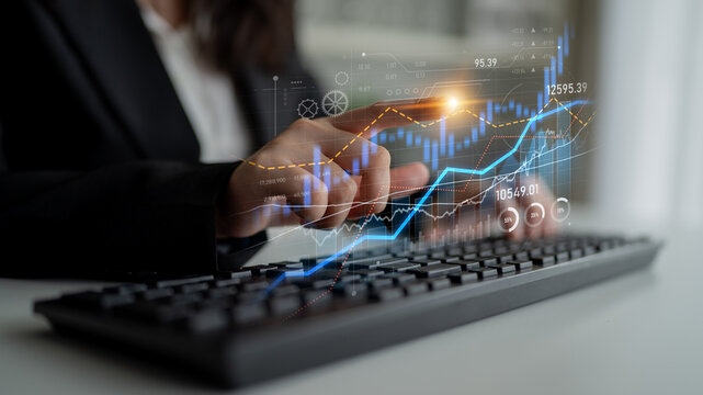 Professional working with digital data insights and financial graphs. A perfect blend of technology and business for investors and managers in an office setting. Scalp