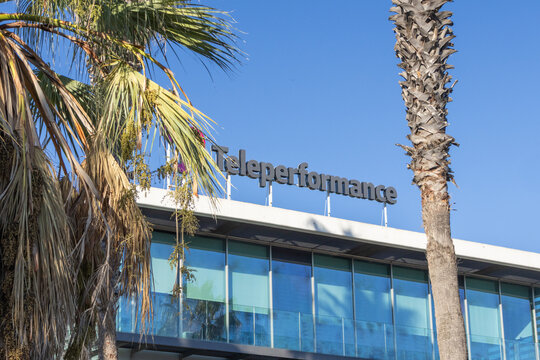 Teleperformance company building in lisbon portugal with palm trees