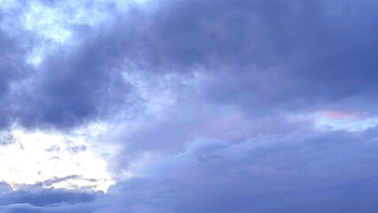 Pink cloud on a purple cloudy sky background