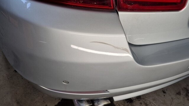Rear bumper of car with scratch