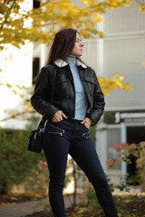 Happy Stylish Woman in Leather Jacket on City Street