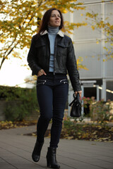 Happy Stylish Woman in Leather Jacket on City Street