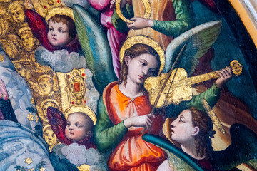 Painting (19th century) of a group of musician angels playing music.