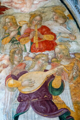 Fresco (14th century) of a group of musician angels in the sky playing music.