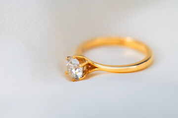 A gold ring with a diamond in the center