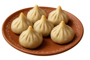 Modak sweet dumplings, traditional indian food for ganesh chaturthi festival, served on an earthenware plate