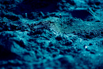 The image is of a blue sand with a blue sky in the background