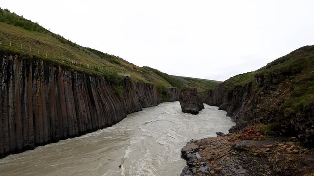 Aerial Stu&eth;lagil Canyon basalt river Iceland
Drone view of the Stu&eth;lagil Canyon with its steep basalt columns rising above the fast-flowing glacial river in Iceland, 2025
