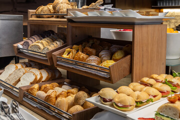 Breakfast buffet with a variety of breads, cereals, yogurt, and desserts