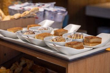 Breakfast buffet with a variety of breads, cereals, yogurt, and desserts