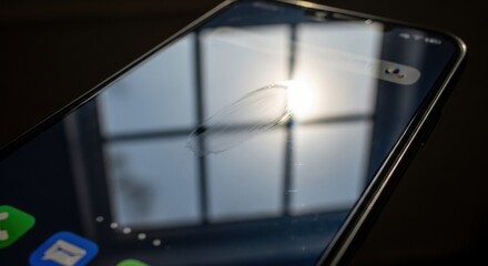 Smartphone screen with smudge reflecting bright window light close-up, detail of dirt marks on glossy display surface
