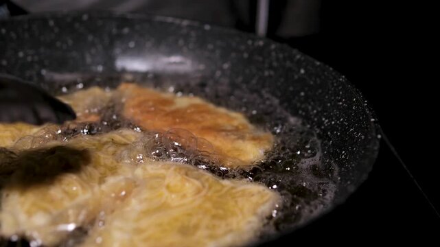 homemade fried fish in batter step by step. step 3 sunflower oil is poured onto a frying pan heated on the stove. High quality 4k footage