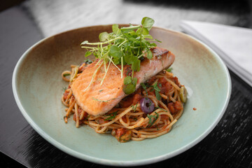 traditional Peruvian food, spaghetti alla puttanesca with trout
