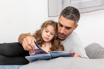 Family man and girl read children book, dad tell daughter story before go to bed