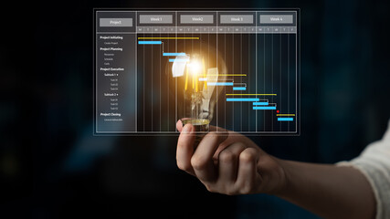 A creative concept showing a hand holding a light bulb while a Gantt chart illustrates project management and planning data in a professional environment. Tessel