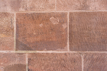 red sandstone brick wall texture. rectangular blocks, rough, weathered, visible tooling marks