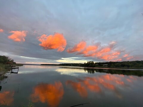 Wide lake panorama with dramatic glowing sunset clouds
