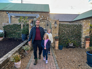 Happy Family Strolling in Garden