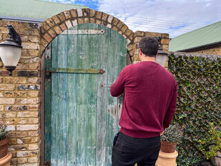 Man Locking Garden Gate