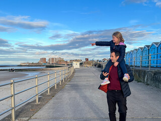 Father and Daughter Walking by the Beach