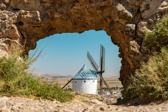 Majestic Consuegra Windmills Framed by Rock Arch, Spain
