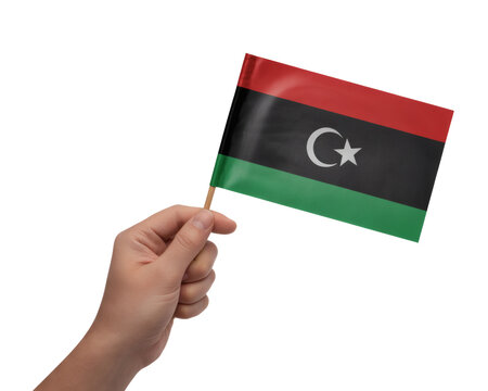 Hand proudly waving the national flag of Libya, celebrating Libyan culture, heritage and independence day with honor