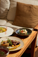 Indulge in an Elegant Dining Experience Featuring Gourmet Dishes Served on a Wooden Table