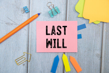 Woman signing Last Will and Testament at wooden table, above view.