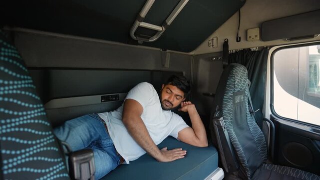 Truck driver waking up refreshed in sleeper cab
