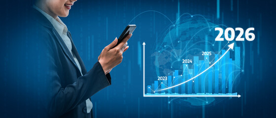 This image depicts a business professional using a smartphone while analyzing futuristic graphs that showcase growth projections from 2023 to 2026. Tessel
