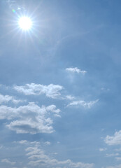 Soft white cumulus clouds spread through a bright blue sky, giving a beautiful cloud landscape with open copy space.