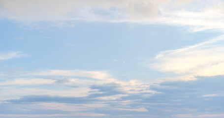 Soft white cumulus clouds spread through a bright blue sky, giving a beautiful cloud landscape with open copy space.