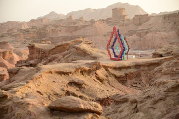 Symbol at Kizil Red Stone Forest Scenic Area in Xinjiang , China is the strangely shaped red rock forests were carved by wind and sand over millions of years. The rocks are red in color.
