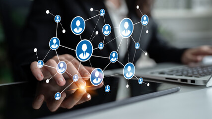 A business professional interacts with a laptop, showcasing a digital network of user icons and connections, symbolizing collaboration and modern communication. Tessel