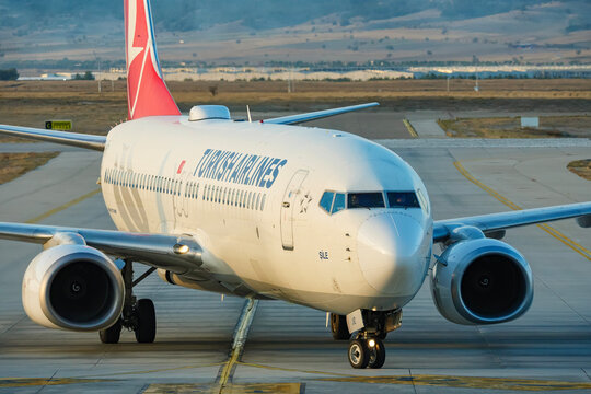 Close up of the nose section of a Turkish Airlines plane showing the pitot tubes and cockpit windows while taxiing on the airport surface