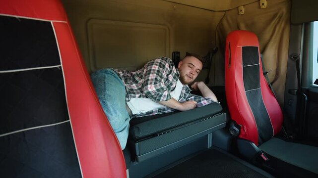 Truck driver waking up after resting in sleeper cab