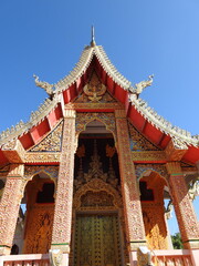 Ornate Golden Thai Temple Architecture Against a Clear Blue Sky