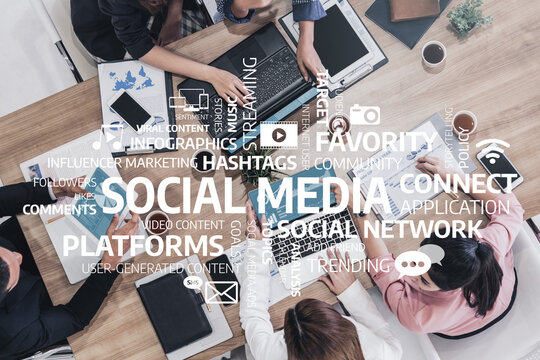 A diverse team collaborates in a modern office, focusing on social media strategies with laptops and engaging discussions, highlighting the importance of digital marketing. Tessel - Powered by Adobe