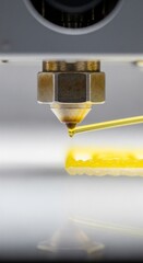 Close-up of a 3D Printer Nozzle Extruding Yellow Material on a White Surface