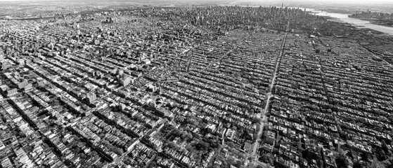 Aerial View of Urban Landscape Showcasing Vast City Grid with Skyscrapers and Residential Blocks in Monochrome