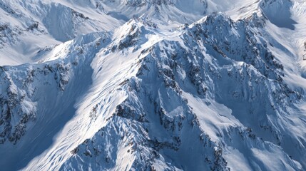 Majestic snow-covered mountain range under bright blue sky showcasing rugged peaks and pristine winter landscape in sunlight