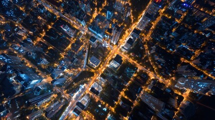Aerial View of a Vibrant Cityscape at Night with Illuminated Buildings and Busy Streets from Above