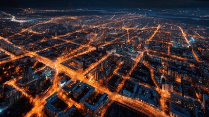Aerial View of Urban Landscape at Night with Bright City Lights and Street Patterns Illuminating the Dark Cityscape
